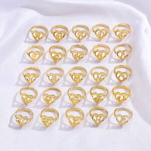 Letter T Lustrous Gold Rings with Intricate Designs